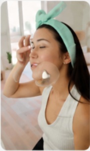 Woman applying skincare cream