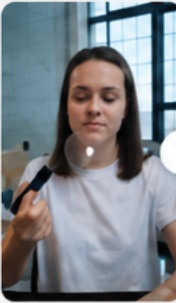 Woman demonstrating a cosmetic brush